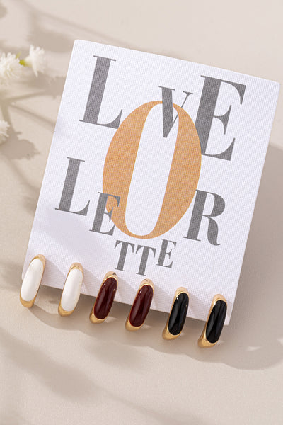 Set of false nails in various colors displayed on a 'LOVE LETTER' card.