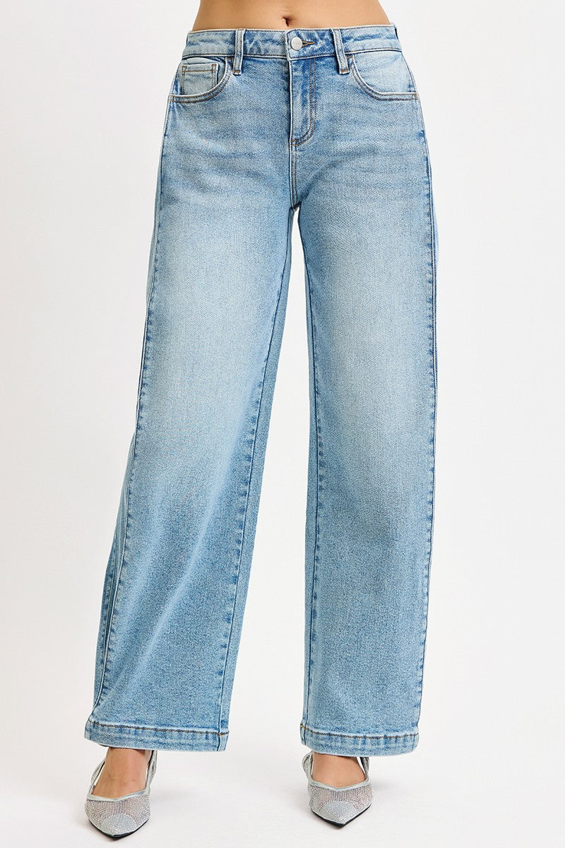 The Wide Barrel Snap Hem Jean in Light Wash — Front View on Model Against White Background Showing Mid-Rise Fit, Wide Barrel Leg Silhouette, Front Seam Detail & Snap-Closed Hem Styled with Silver Kitten Heels