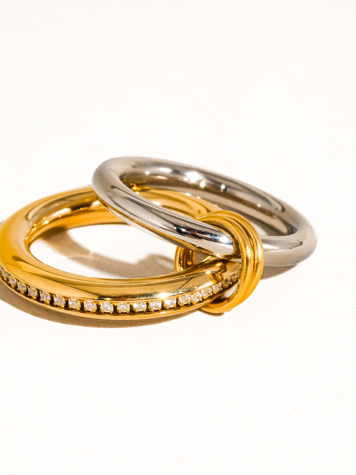 The Multi Stack CZ Band Ring Set in 18K Gold & Silver - Product Detail Shot on White Background Showing Gold CZ Channel Band & Silver Band Interlocked via Slim Gold Connector Ring from Side Angle