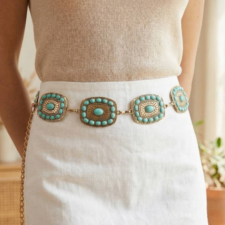 The Mesa Turquoise Rectangle Concho Chain Belt in Gold - Styled on Model at Waist Over Cream Knit Top & White Linen Skirt Showing Rectangle Concho Plaques with Turquoise Halo Studs