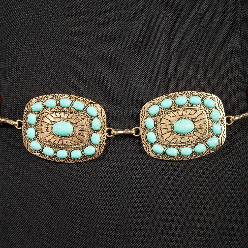 The Mesa Turquoise Rectangle Concho Chain Belt in Gold - Close-Up Detail on Dark Background Showing Two Rectangle Concho Plaques with Turquoise Cabochon Center Stone & Halo Stud Cluster