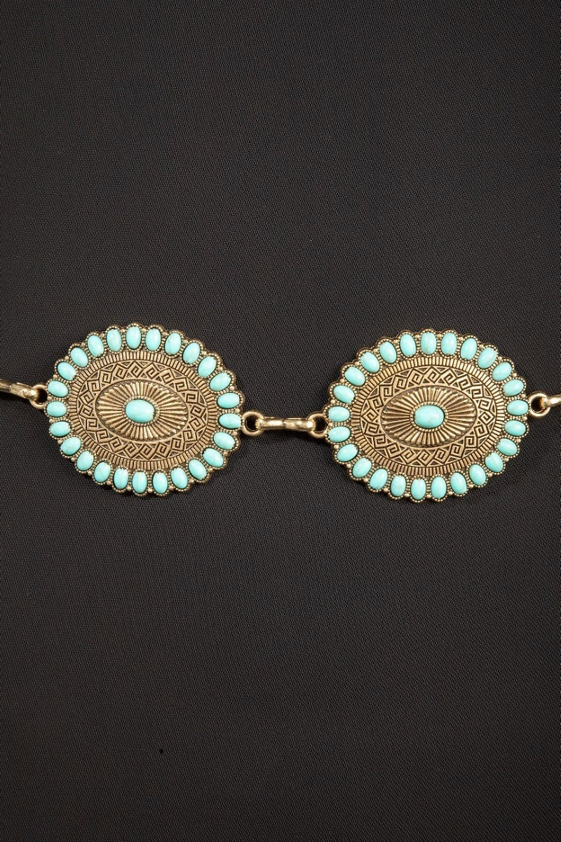 The Turquoise Concho Chain Belt - Close-Up Detail on Dark Background Showing Sunburst Engraving, Turquoise Stud Border & Center Stone on Two Concho Discs