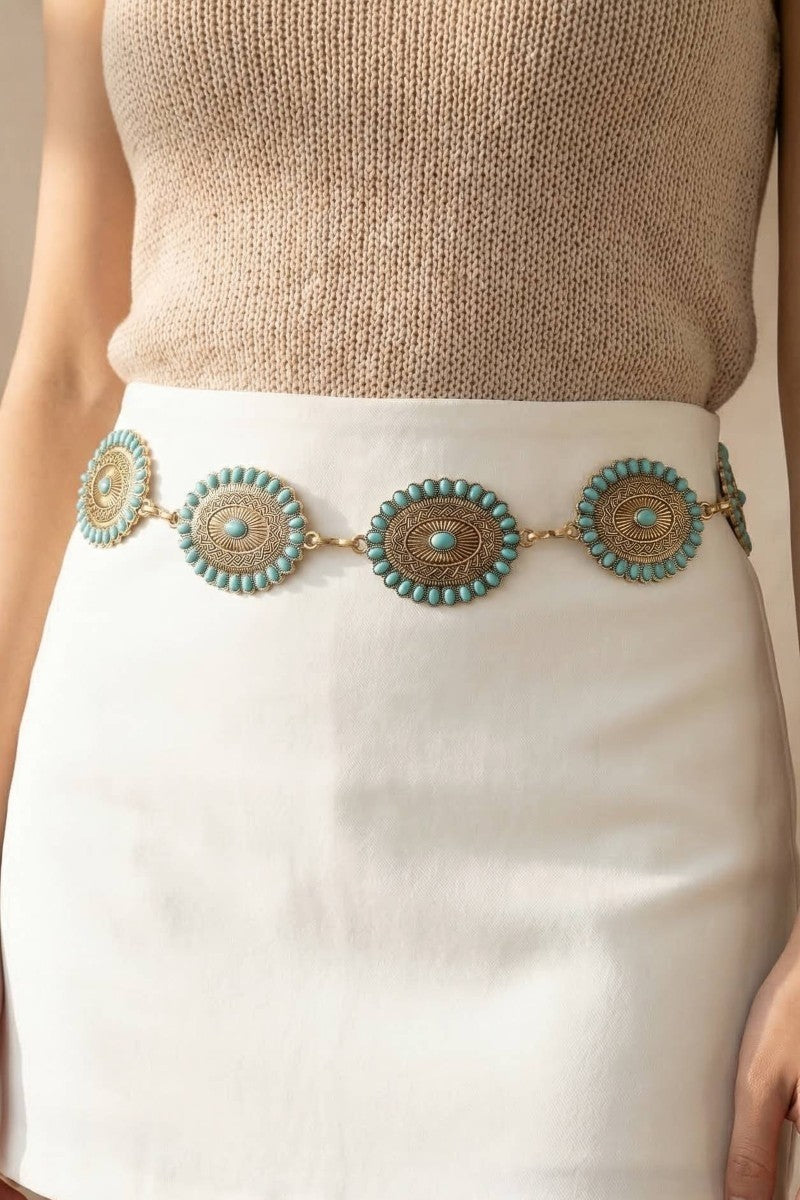 The Turquoise Concho Chain Belt - Styled on Model at Waist Over Cream Knit Top & White Mini Skirt Showing Oval Concho Discs with Turquoise Stud Border