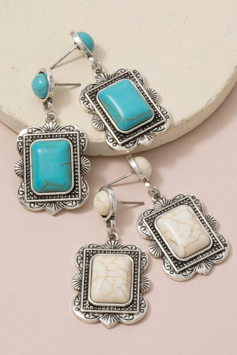 The Concho Rectangle Stone Drop Earrings - Both Colorways Flat Lay on Cream Surface Showing Turquoise & White Howlite Antique Silver Rectangle Concho Drop Earrings Side by Side