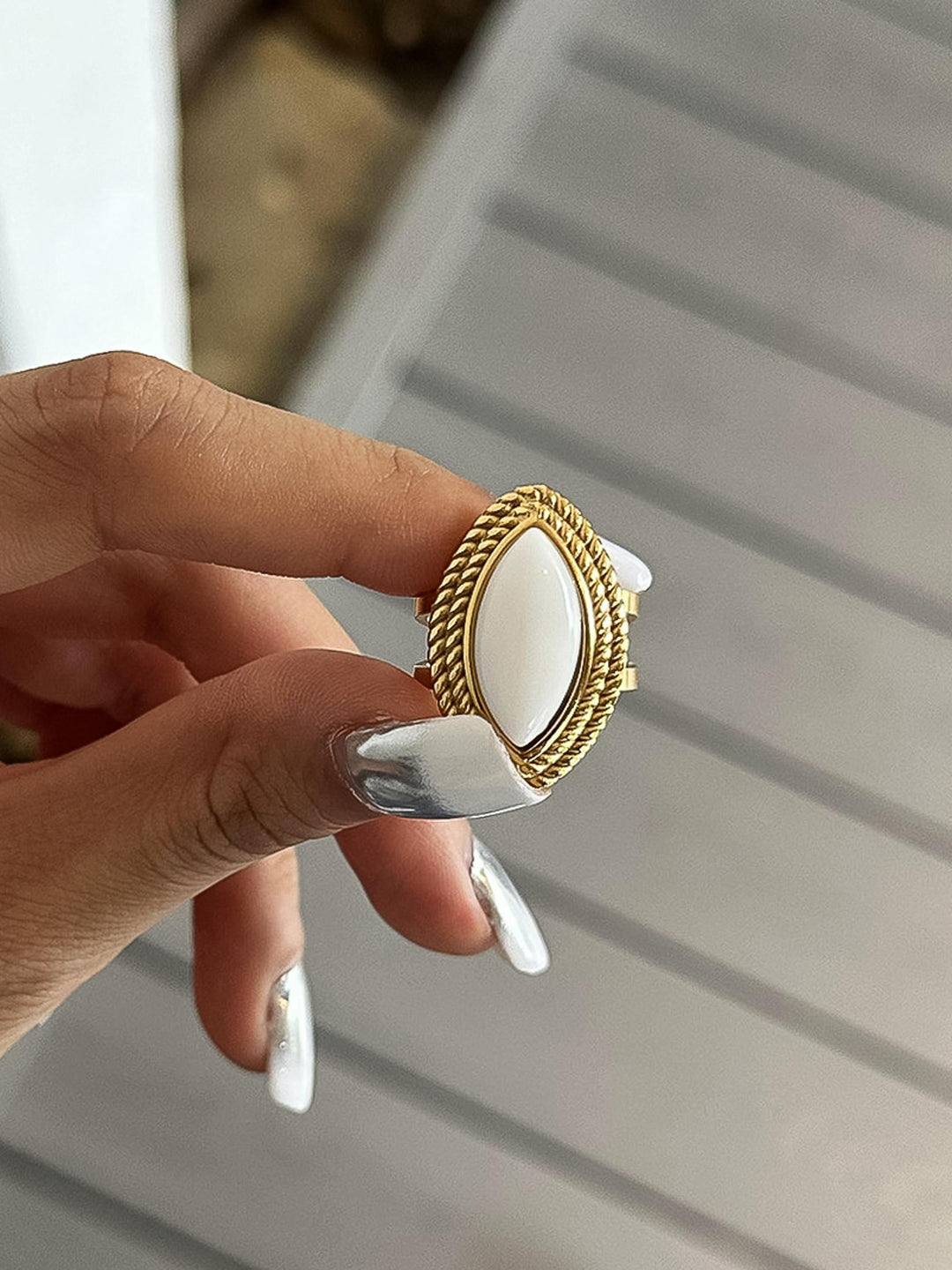 The Vintage Marquise Stone Statement Ring in 18K Gold - On-Model Close-Up Showing Ring Held Between Fingers Displaying Full Marquise Stone Face, Rope Bezel Detail & Split Double Band Back