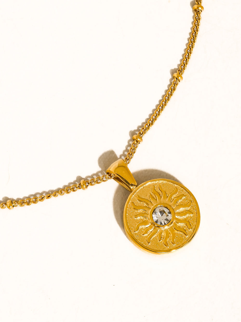 The CZ Sun Medallion Coin Necklace in 18K Gold - Product Shot on White Background Showing Full Satellite Curb Chain with Round Sun Medallion Coin Pendant, Engraved Sun Motif & CZ Bezel Center Stone