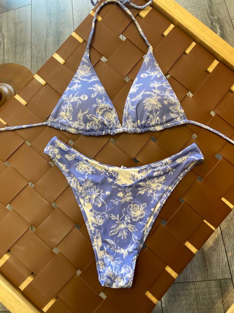 The Jane Reversible Bikini Set - Flat Lay on Rattan Surface Showing Side 1 Blue Floral Triangle Top & Full Coverage Bottoms