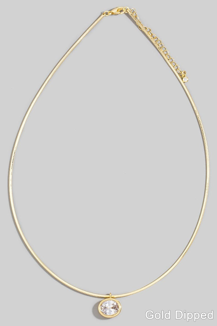 The Oval CZ Bezel Snake Chain Necklace in Gold Dipped - Full Product Flat Lay on Grey Background Showing Complete 14 Inch Snake Chain, Oval CZ Bezel Pendant & Lobster Clasp with 2 Inch Extension