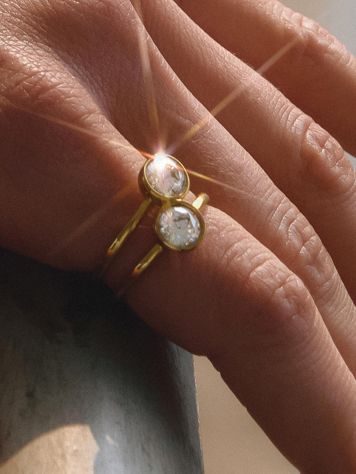 The Double CZ Bezel Stacked Ring in 18K Gold - On-Model Close-Up on Hand Showing Double Band Silhouette with Two Round Brilliant CZ Bezel Stones Catching Light