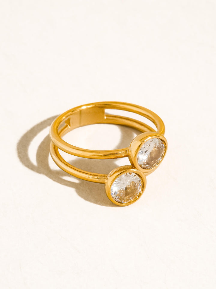 The Double CZ Bezel Stacked Ring in 18K Gold - Product Three-Quarter View on Cream Background Showing Double Band Profile, Round CZ Bezel Settings & Polished 18K Gold Finish