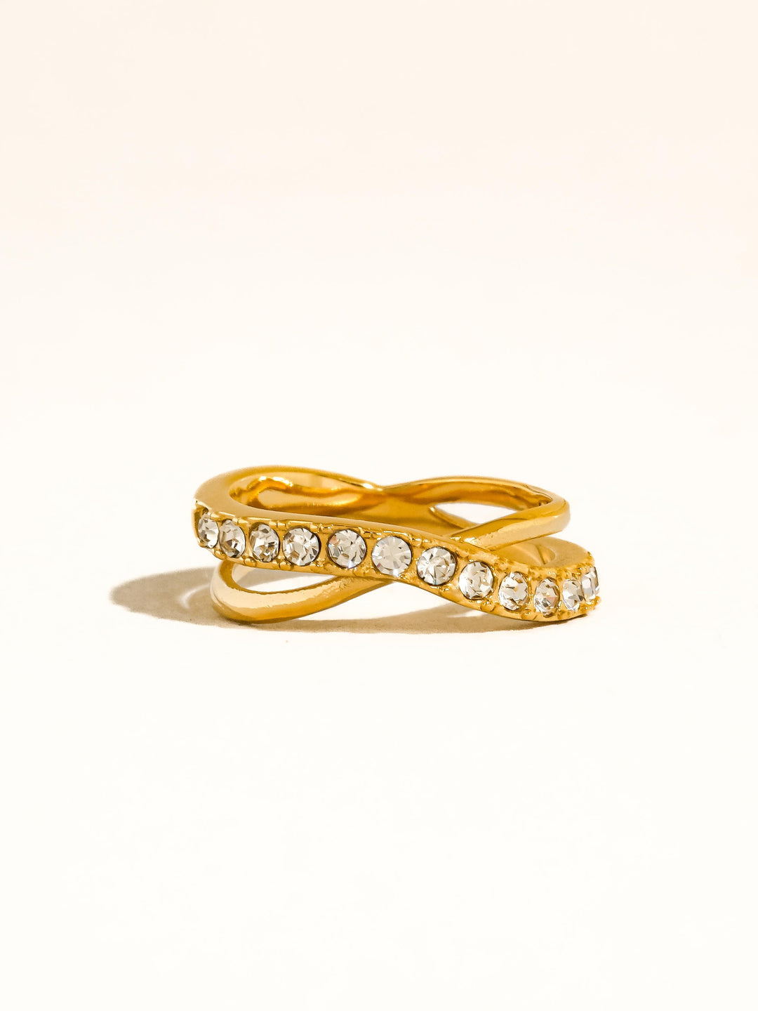 The CZ Pavé Crossover Ring in 18K Gold - Product Shot on Cream Background Showing Front View of Two-Band Crossover X Silhouette with Pavé CZ Band & Smooth Gold Band