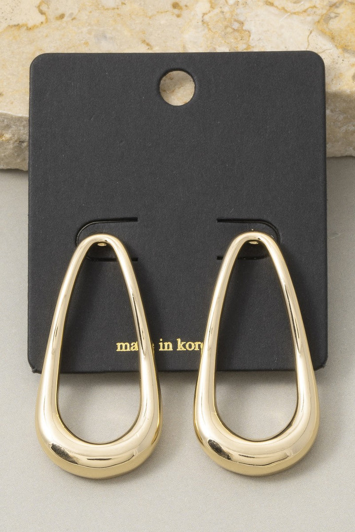 The Contour Open Teardrop Drop Earrings in Gold - Product Shot on Black Card Against Marble Background Showing Pair of Polished Gold Open Teardrop Earrings