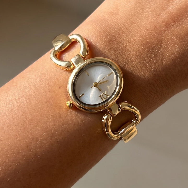 Gold Oval Case Roman Numeral Horsebit Link Bracelet Watch