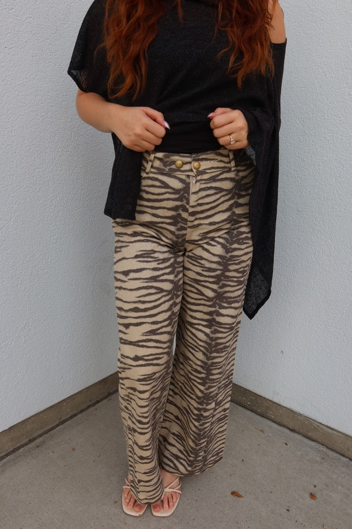Close front view of the Tiger print belted wide leg woven pants, showing the high waist and gold button