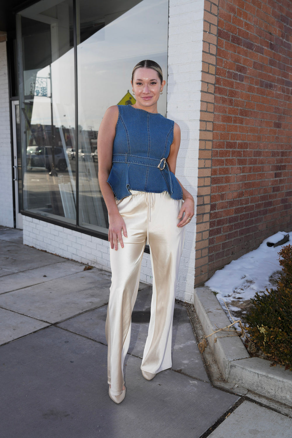 Cream colored satin pants with drawstring waist and sleek straight leg fit