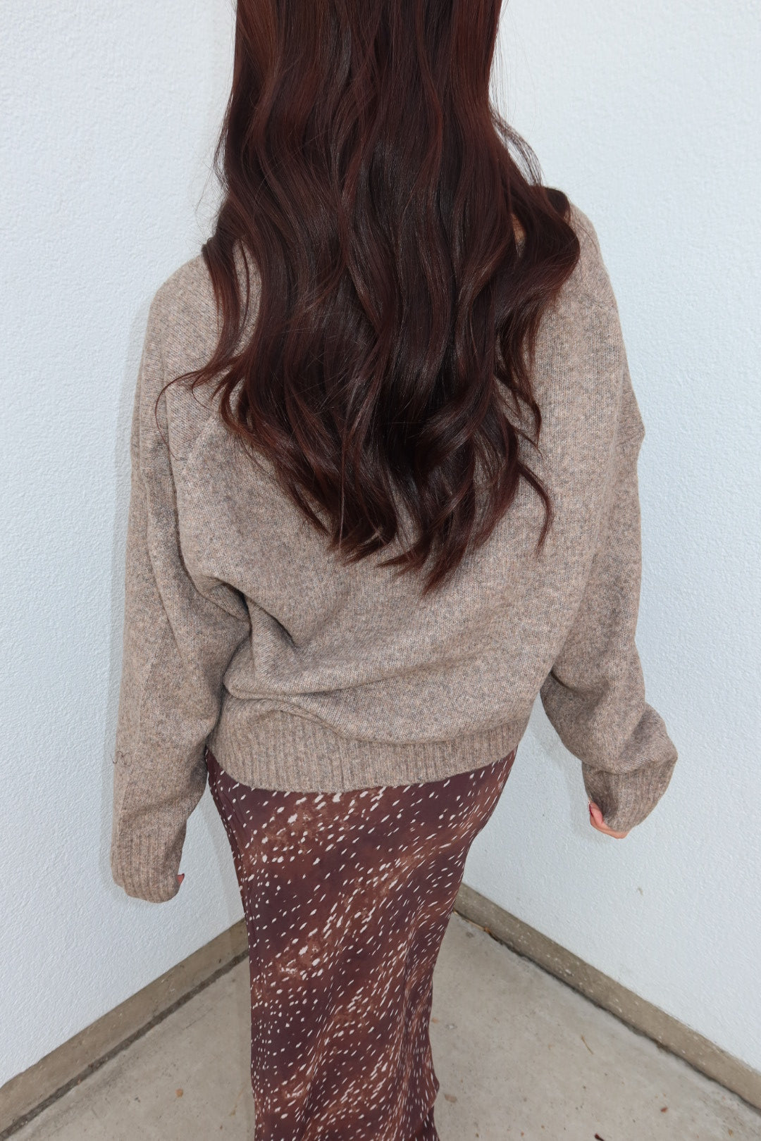 Close back view of the taupe Viloria V-neck oversized sweater, showing the oversized fit and long sleeves