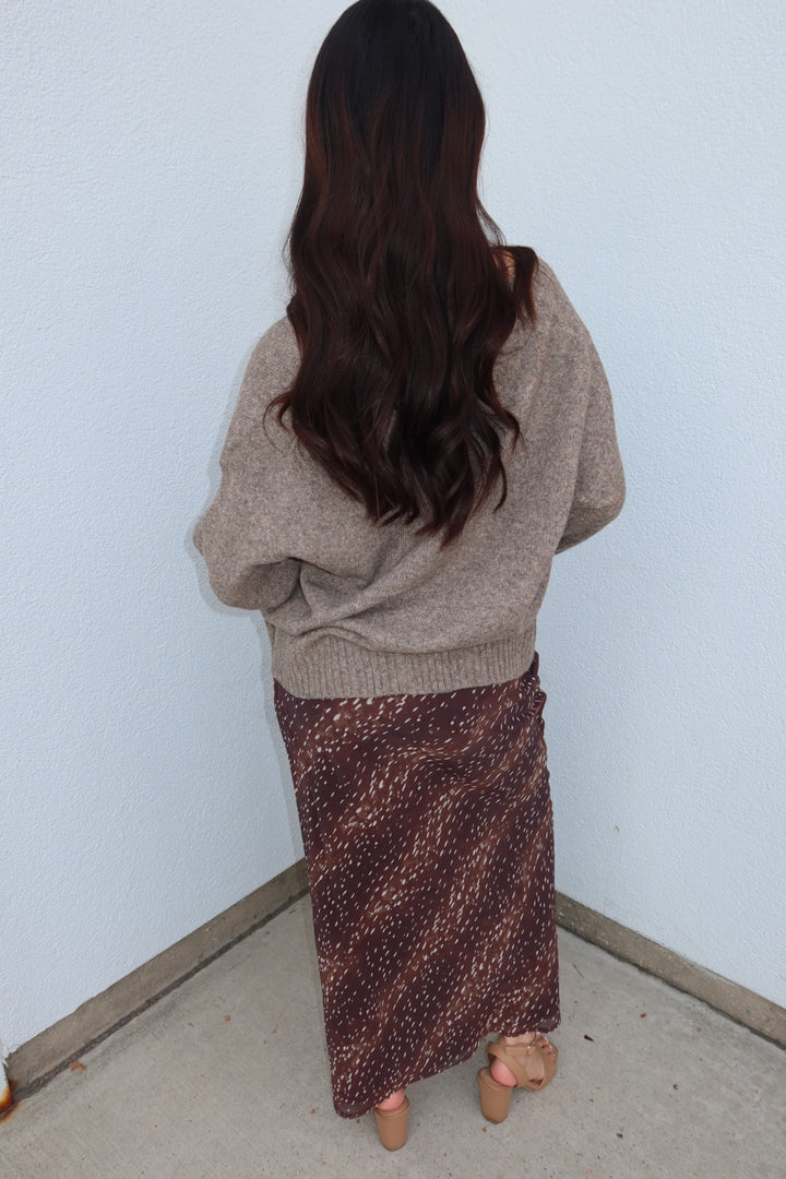 Back view of the burgundy print Bambi fluid maxi slip skirt, full length, with tan heeled sandals