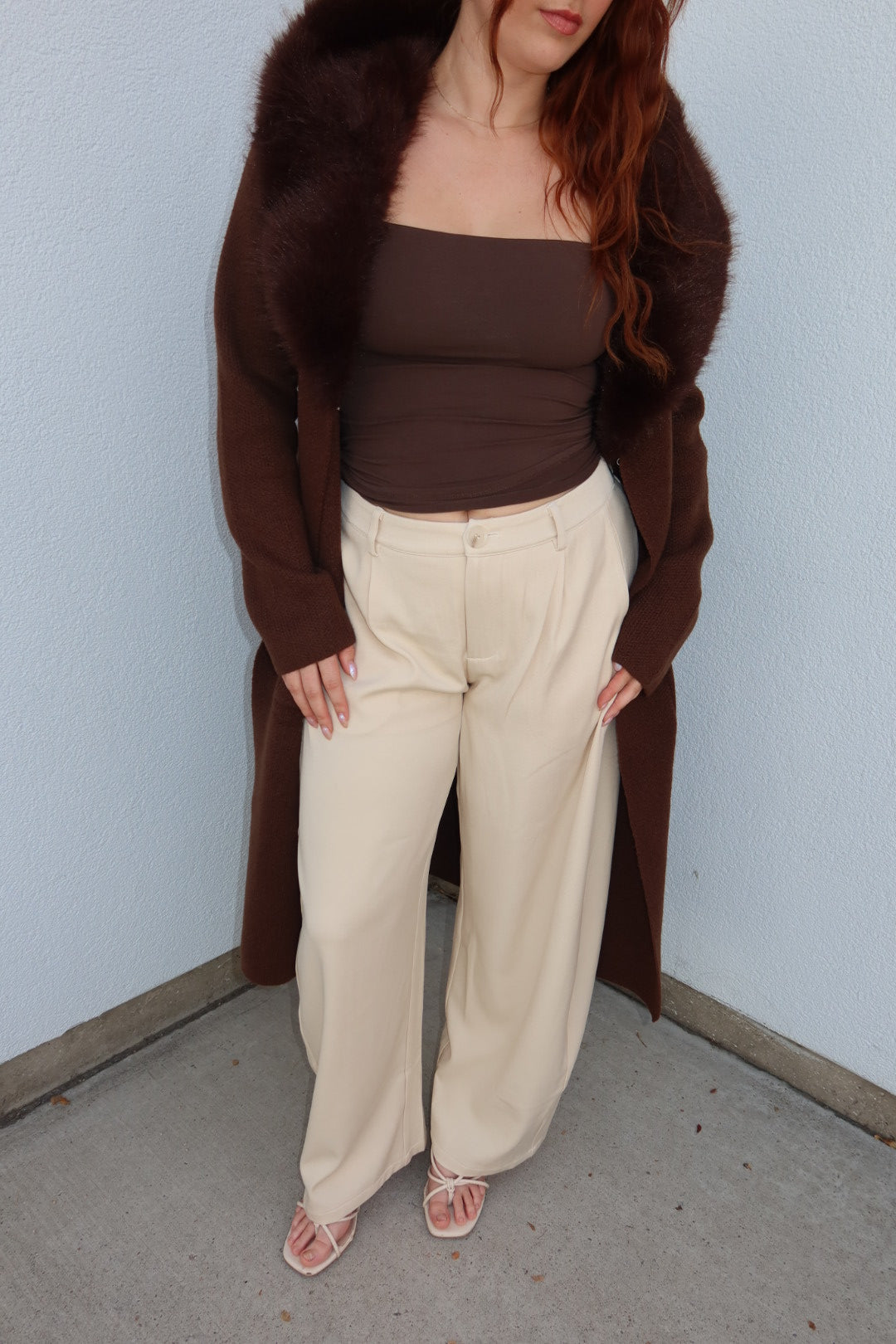 Front view of the cream Louis low waist pleated barrel wide leg pants with a brown top and strappy sandals
